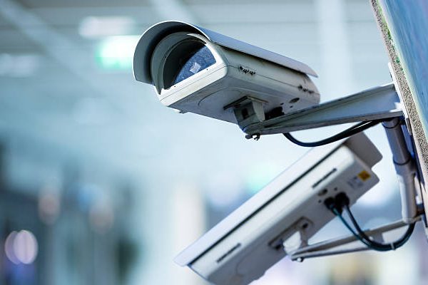 closeup image of CCTV security camera with blurred background